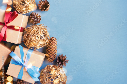 Christmas background with gift boxes and cones on blue background. Gift boxes...