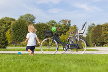 Kleines Kind Auf Familienausflug Mit Fahrrad In Park. Child Playing In Nature With Vintage Bike.