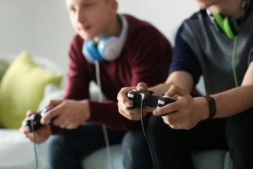 Wall Mural - Teenagers playing video games at home