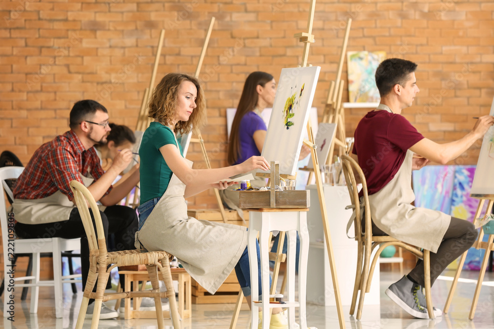 Group of people during classes in school of painters