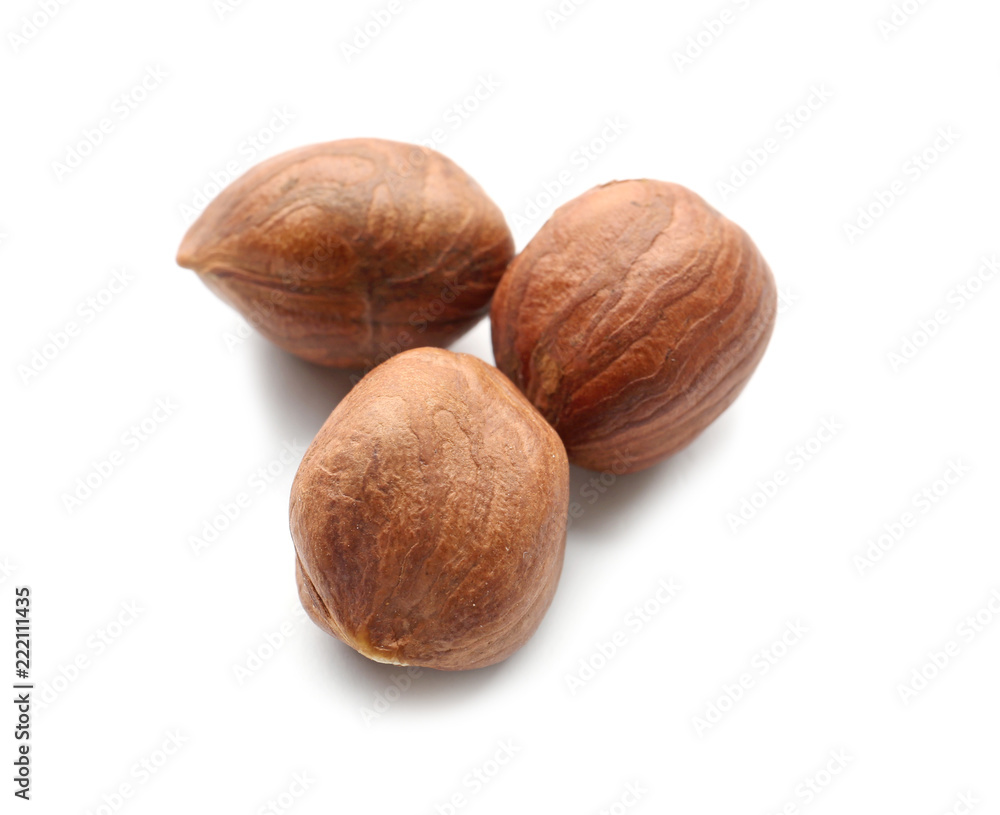 Tasty hazelnuts on white background