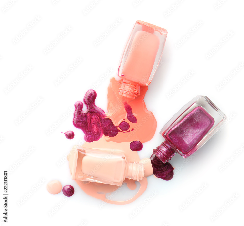 Open bottles of nail polishes on white background