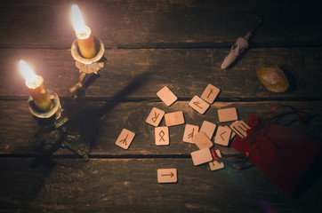 Magic divination runes on fortune teller desk table background. Futune reading concept.