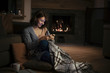 © LStockStudio - A Woman Enjoying Wintertime and Typing on Cell Phone