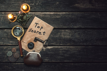 Wall Mural - top secret documents file, key, magnifying glass and wallet with coins on the detective spy agent ta