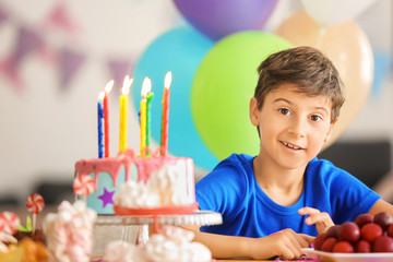 Poster - Cute little boy at table with birthday cake