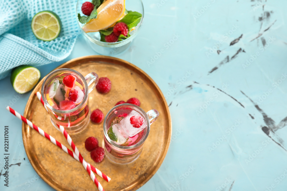 Glasses of fresh raspberry mojito on table