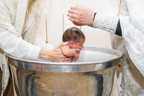 Cuadros en Lienzo Mother holds child while priest baptizes with holy water
