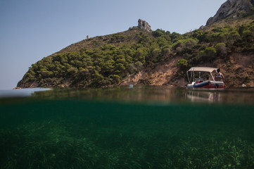 Wall Mural - half underwater view of the hill sella del diavolo - Marina piccola - Cagliari Sardinia