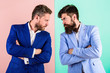 © be free - Businessmen stylish appearance jacket pink blue background. Tense face expression competitors. Business competition and confrontation. Business partners competitors in suits with tense bearded faces