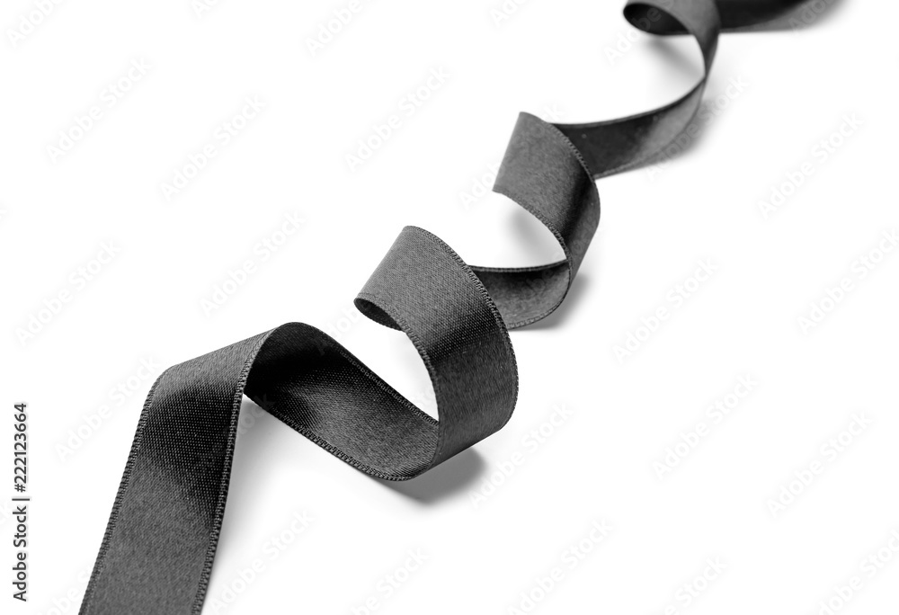 Curled black ribbon on white background