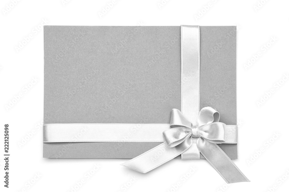 Blank paper card with silver ribbon and bow on white background