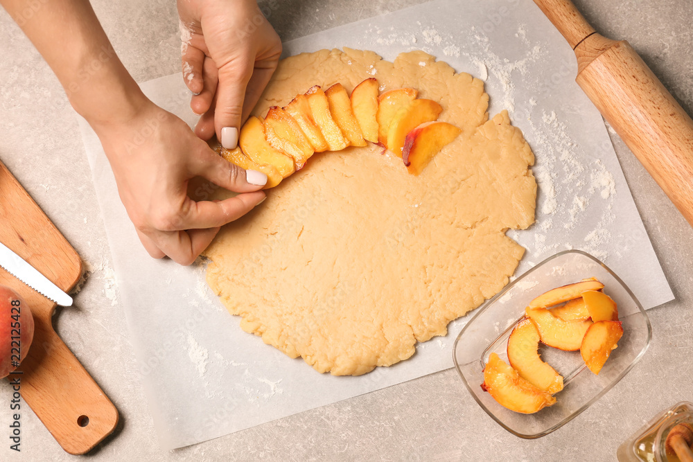 Woman preparing peach galette