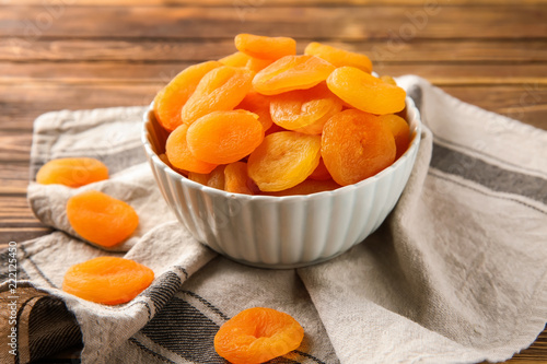 Cuadros en Lienzo Bowl with dried apricots on table