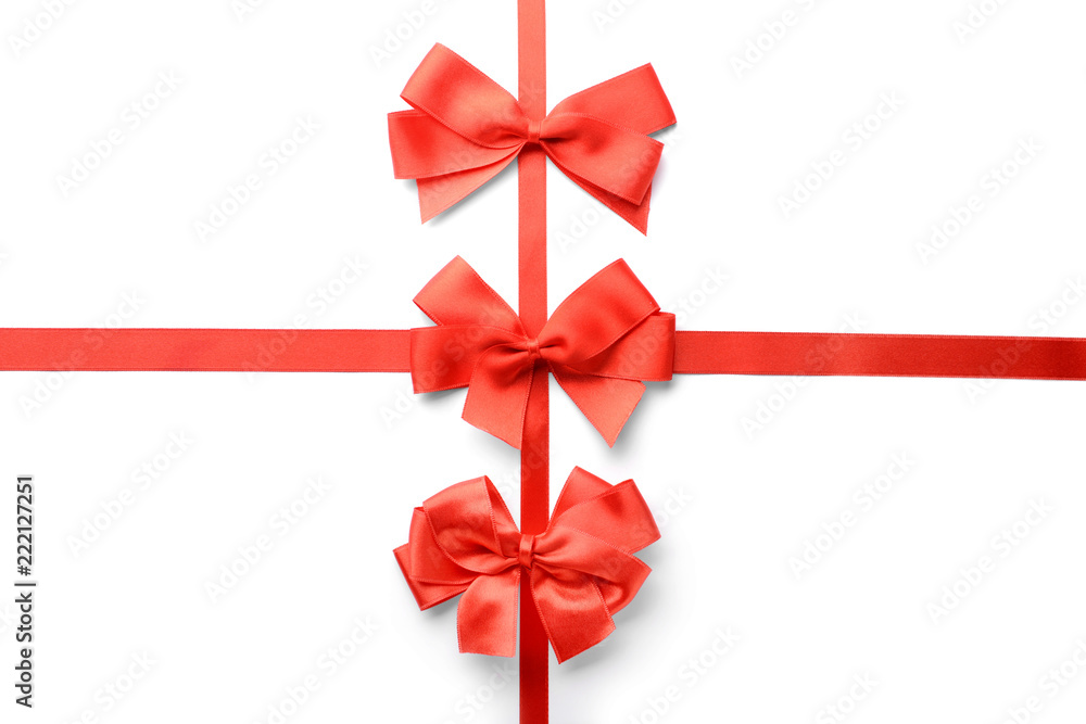 Red ribbons with beautiful bows on white background