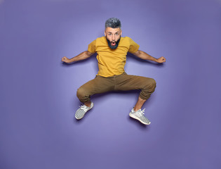 Poster - Active jumping man on color background