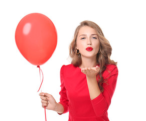 Poster - Beautiful young woman with balloon blowing kiss on white background