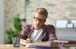 © Pixel-Shot - Teenager boy doing homework at home