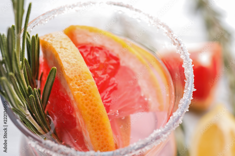 Fresh grapefruit cocktail with rosemary in glass, closeup