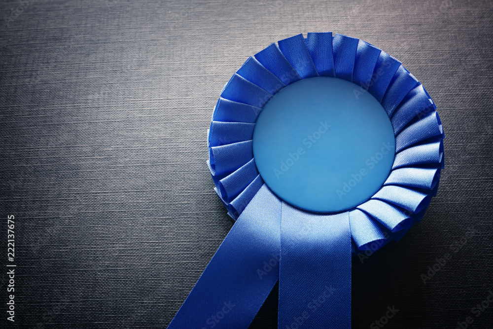 Blue award rosette with ribbons and copy space - obrazy, fototapety, plakaty 