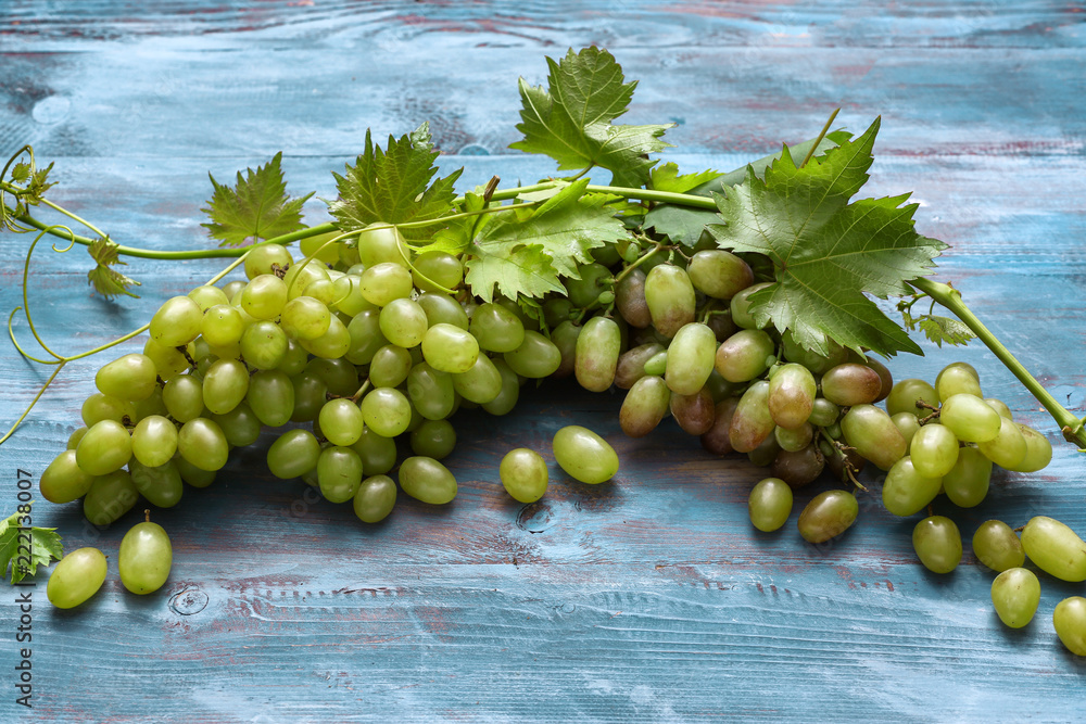 Fresh ripe grapes on wooden table