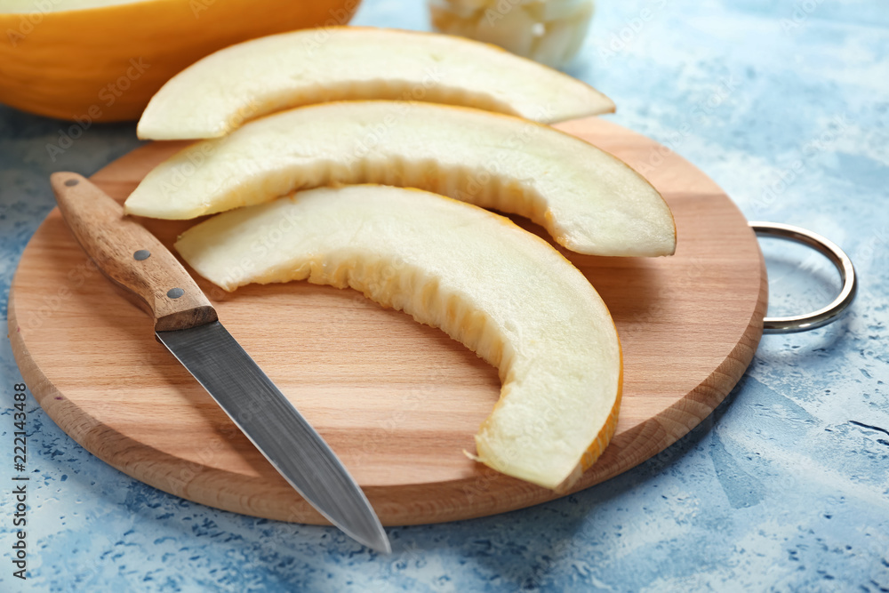 Slices of ripe melon on wooden board