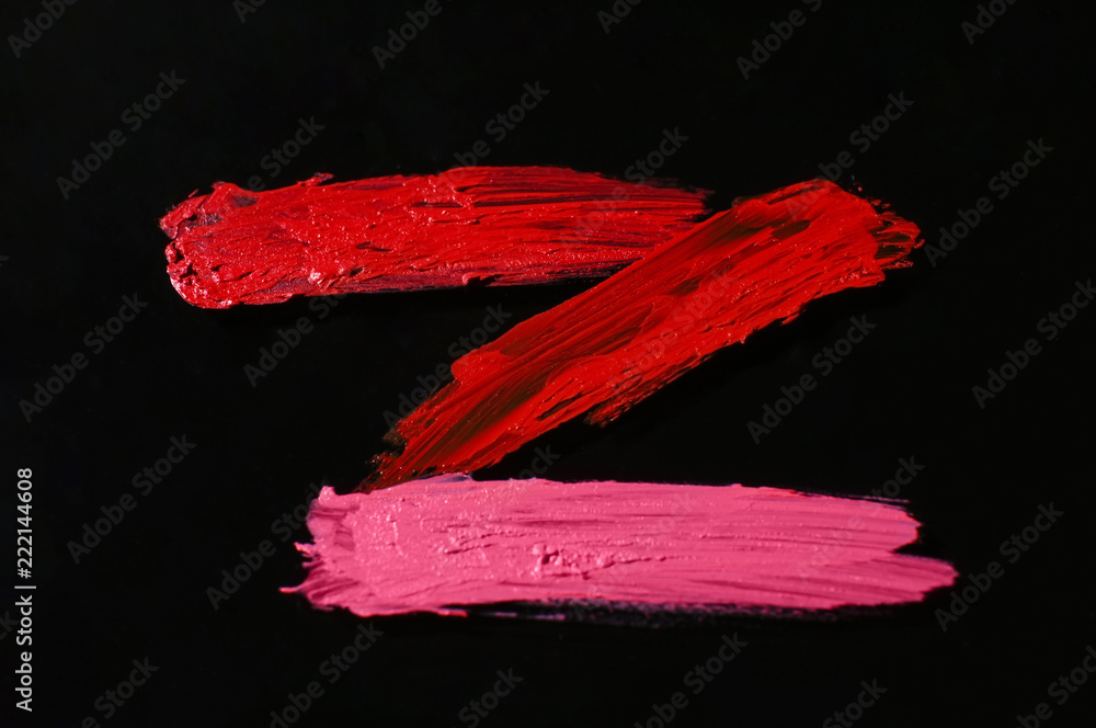 Strokes of color lipsticks on dark background