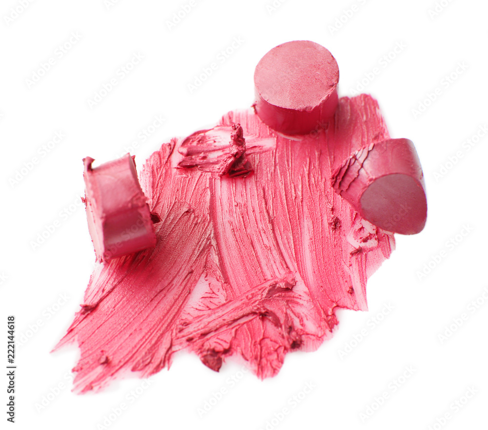 Broken pink lipstick with strokes on white background