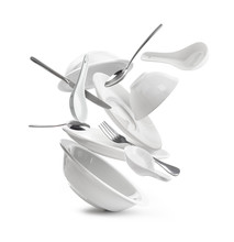 Falling Dishes With Cutlery On White Background