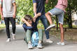 © Pixel-Shot - Aggressive teenagers bullying boy outdoors