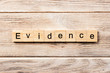 evidence word written on wood block. evidence text on table, concept