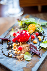 Wall Mural - Salad with Goat Cheese glazed in Strawberry Jam, Beetroot, Rucola Leaves and Pine Nuts in Luxury Restaurant for the Dinner