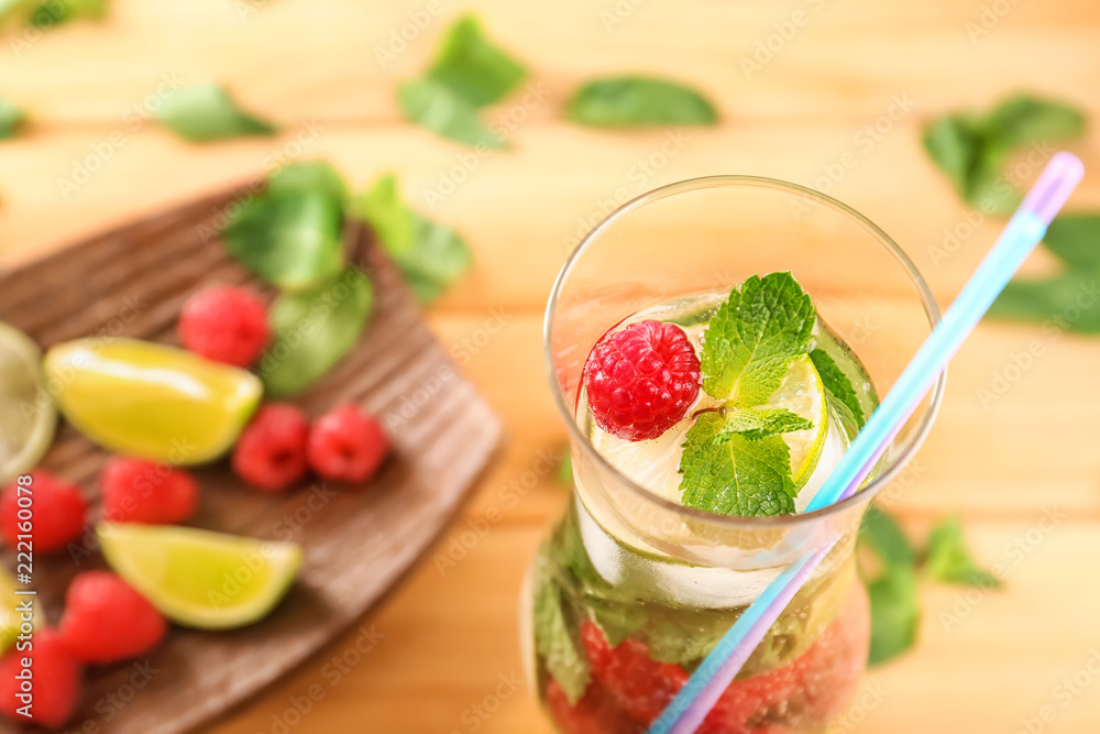 Glass of fresh raspberry lemonade on wooden table, closeup