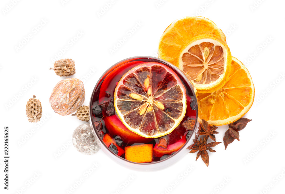 Glass of delicious mulled wine on white background