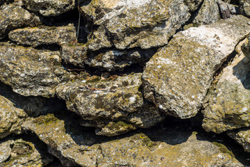 Stones background, gray large stones, boulders in the masonry, part of stone fence, close-up of stone border