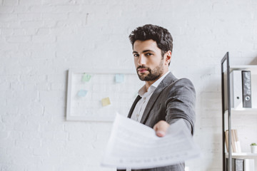 Wall Mural - handsome businessman showing documents in office