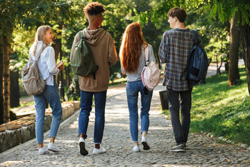 Wall Mural - Back view group of young students with backpacks