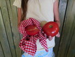 girl holding tomato