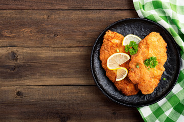 Homemade breaded german weiner schnitzel with potatoes. top view