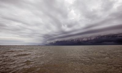 Wall Mural - Cloudy storm in the sea before the rain. tornado storms cloud above the sea. Monsoon season. Hurricane Florence. Hurricane Katrina.
