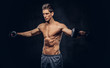 © Fxquadro - Handsome shirtless man with stylish hair and muscular ectomorph body doing the exercises with dumbbells.