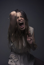 Crazy, Deranged Young Woman Screaming With Frustration, Expressing Madness And Rage