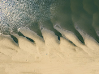 Poster - top aerial view of young hipster sitting on the abstract sandy sea beach. summer exotic concept d