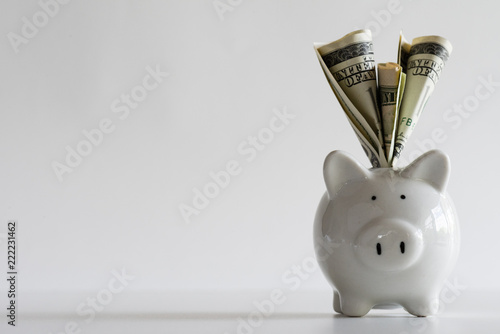Fotografía America dollars banknotes money into piggy bank on white background