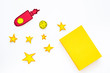 © 9dreamstudio - Literature for children. Fantactic, fiction story. Book with blank cover near cutout of rocket, stars, moon on white background top view mockup