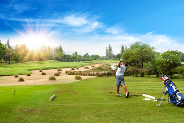 Sticker - 13-year-old Asian boy hit sweeping golf ball on a golf course in the sunrise, sunset time in holiday.