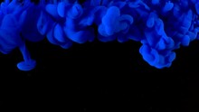 Deep Blue With Glitter Ink In Black Underwater. Colour Indigo Gloss Paint Reacting In Water Creating Abstract Smoke Cloud Formations. Can Be Used As Transitions, Added To Projects.