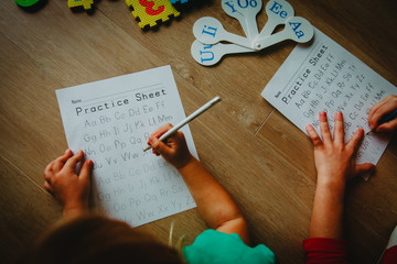 Wall Mural - kids learning to write letters doing homework