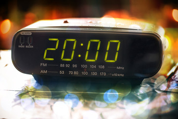 Wall Mural - Black digital alarm radio clock.Alarm radio clock indicating time to wake up.Digital clock closeup displaying 20:00 o'clock.