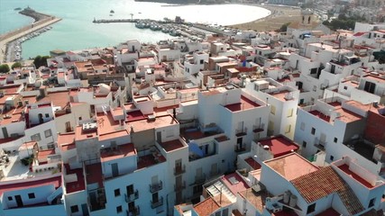 Wall Mural - Peniscola, Spain, Summer 2018. Smooth drone flight over the roofs of the old city. Aerial view